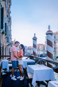 People sitting on table against buildings