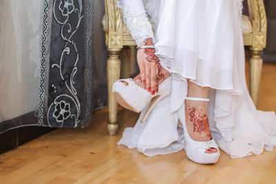 Low section of women standing on wooden floor
