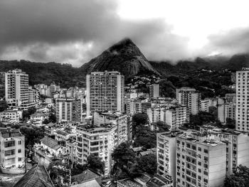 View of cityscape against cloudy sky