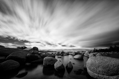 Cloudy sky above rocky stream