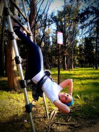 Man sitting on swing in park