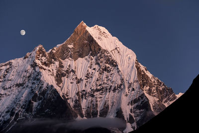 Panoramic view of snowcapped mountains against clear sky