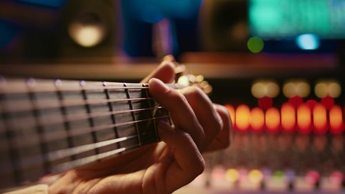 Cropped hand playing guitar