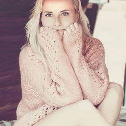 Portrait of beautiful young woman sitting outdoors