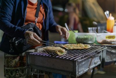 Man preparing food on barbecue grill