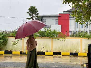 Full length of man standing on wet rainy day