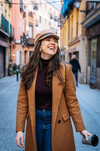 Young woman smiling in city during winter