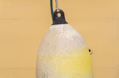 Close-up of buoy against yellow boat
