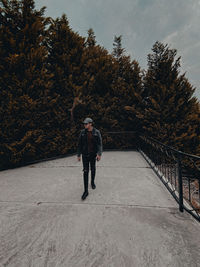 Full length of man standing by tree during winter