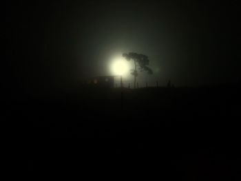 Silhouette landscape against clear sky at night