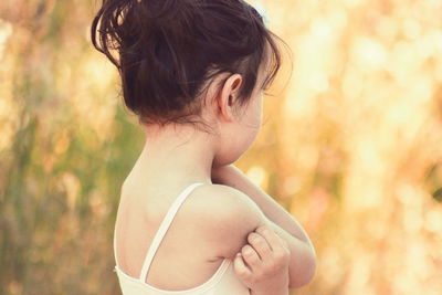 Rear view of girl standing outdoors