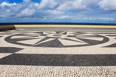 Surface level of road by sea against sky