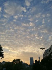 City against sky at sunset