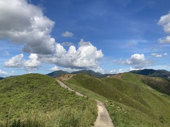 Panoramic view of road leading towards mountains against sky