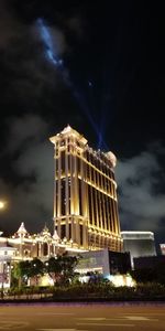 Low angle view of illuminated building against sky at night