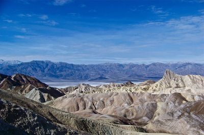 Scenic view of mountains against blue sky