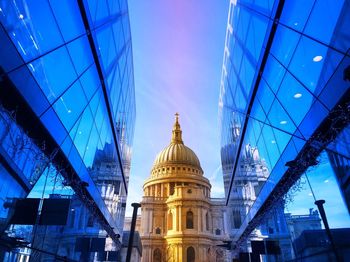 Low angle view of illuminated building against blue sky