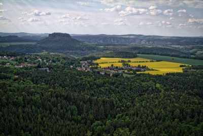 Scenic view of landscape by lilienstein mountain against sky