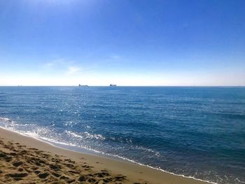 Scenic view of sea against clear blue sky