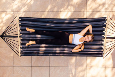 Directly above shot of woman lying on hammock