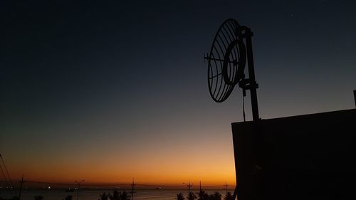 Low angle view of silhouette building against sky during sunset