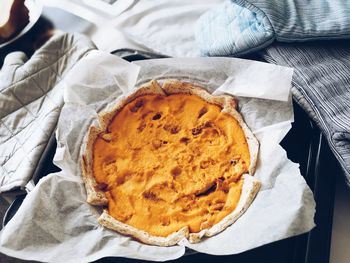 High angle view of pumpkin pie in container on table