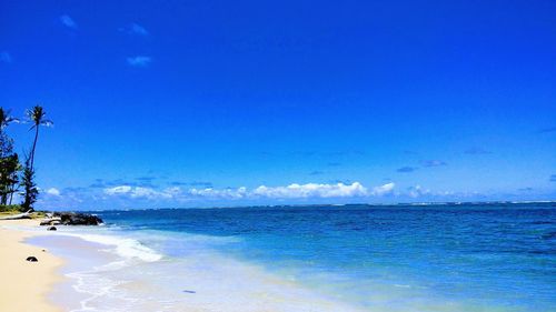 Scenic view of sea against blue sky