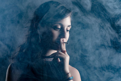 Portrait of woman smoking cigarette