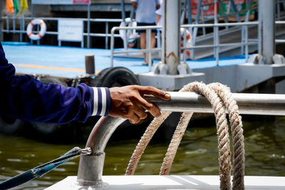 Close-up of hand holding rope