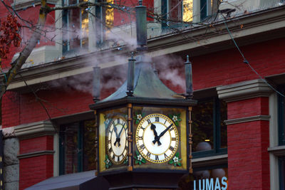 Low angle view of clock tower in city