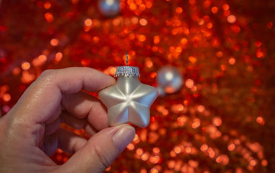 Close-up of hand holding christmas decoration
