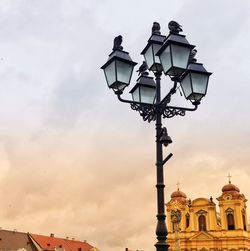 Low angle view of street light against building