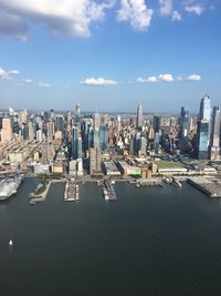 Aerial view of buildings and sea against sky