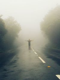 Road passing through foggy weather