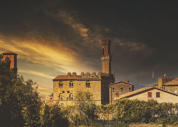 Old building against sky at sunset