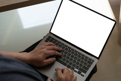 Midsection of man using laptop