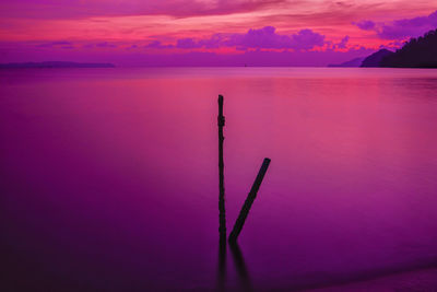 Scenic view of sea against romantic sky at sunset