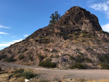 Low angle view of rock formations against sky