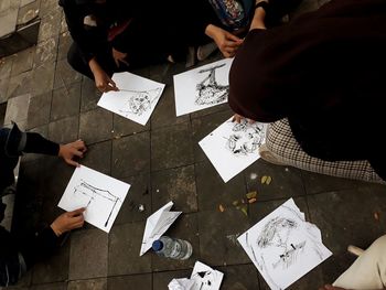 High angle view of people walking on tiled floor