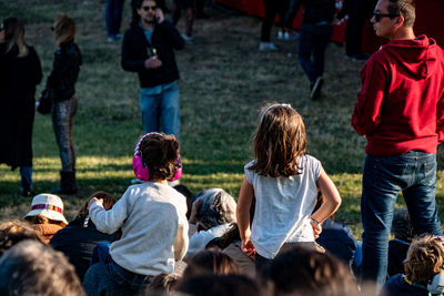 Rear view of people enjoying on field