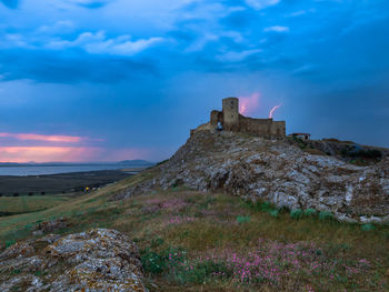 Built structure on land against sky