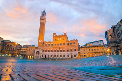 Buildings in city at sunset