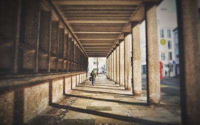 Rear view of people walking on corridor