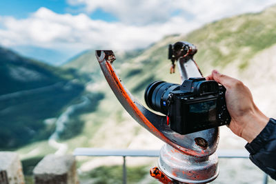 Cropped hand of person photographing