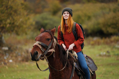 Portrait of teenage girl riding horse