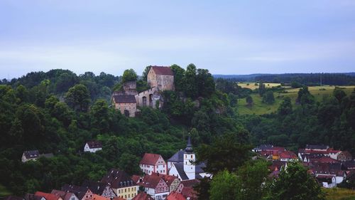 Buildings in town against sky