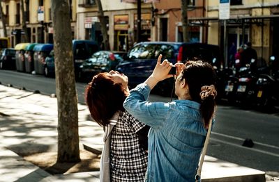 Rear view of woman sitting in park