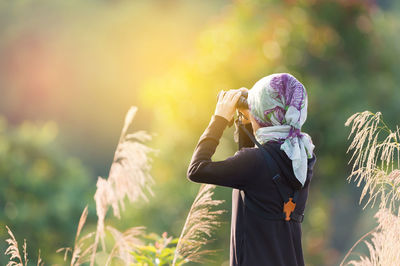 Full length of girl standing against plants