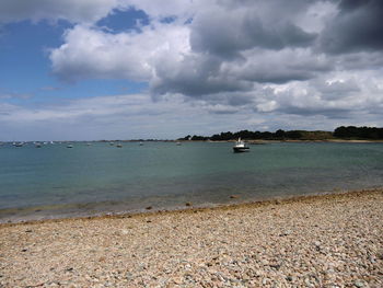 View of calm sea against cloudy sky