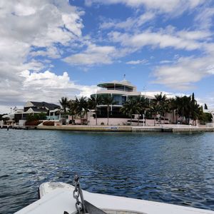 Buildings by sea against sky